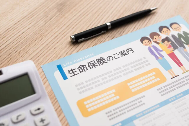 生命保険のパンフレットと電卓
